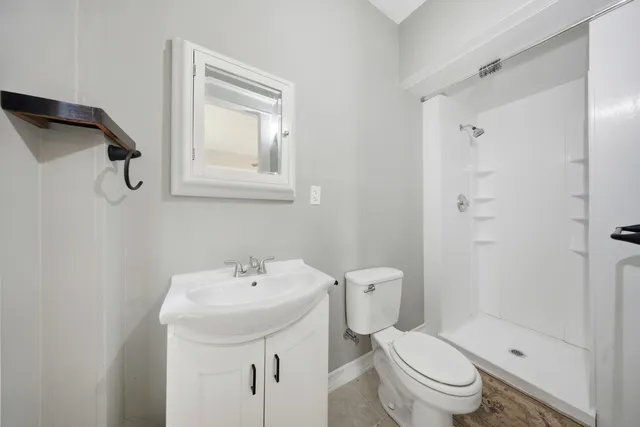 a bathroom with a toilet sink and shower