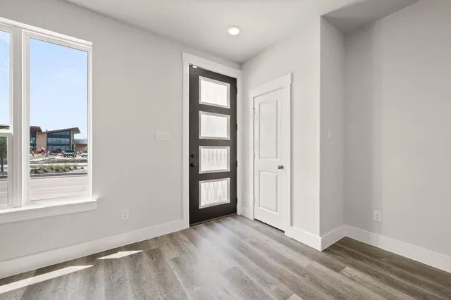 an aerial view of residential houses with outdoor space and ocean view