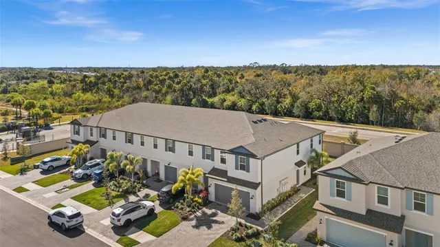 an aerial view of a house with a big yard
