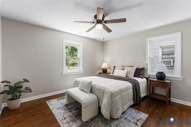 a bedroom with bed couch and window
