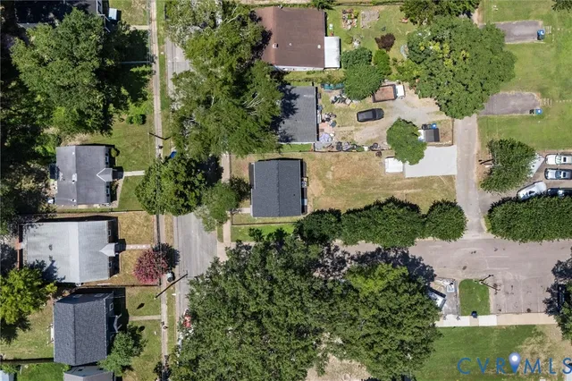 an aerial view of a house with a yard and lake view