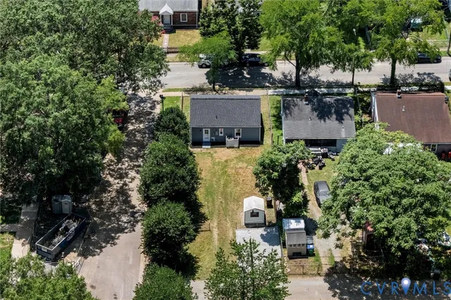 an aerial view of a house with a yard and lake view