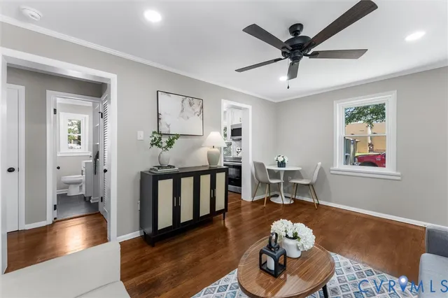 a living room with furniture and wooden floor