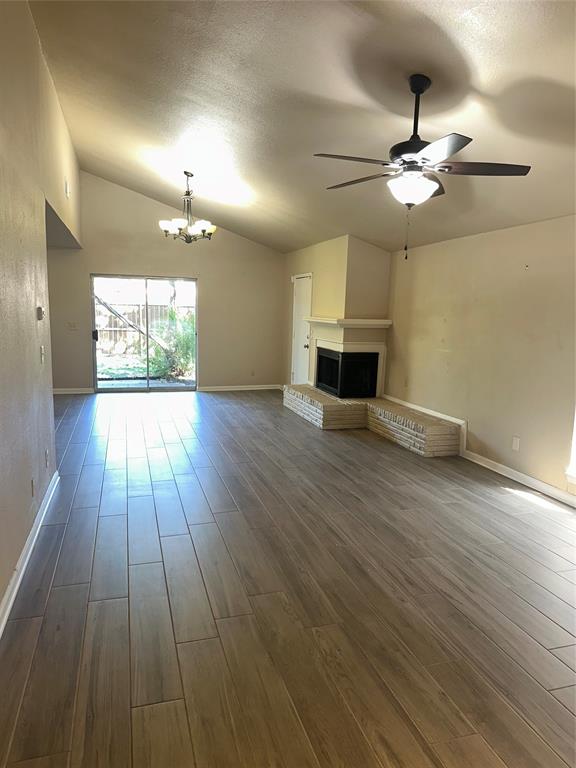 1315 North Floyd Road Richardson, TX 75080 - Photo 11 of 26 a view of a livingroom with wooden floor a ceiling fan and windows