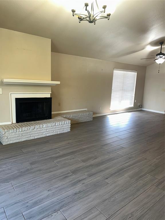 1315 North Floyd Road Richardson, TX 75080 - Photo 12 of 26 a view of an empty room with wooden floor and a fireplace