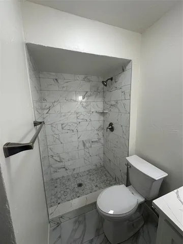 a bathroom with a toilet and shower