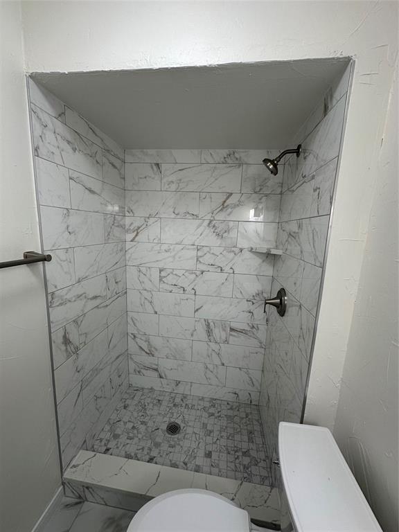 1315 North Floyd Road Richardson, TX 75080 - Photo 20 of 26 a bathroom with a toilet and a shower