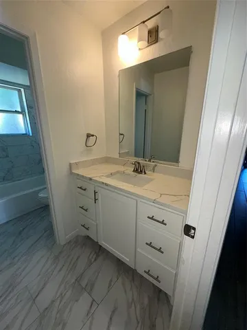 a bathroom with a double vanity sink and mirror