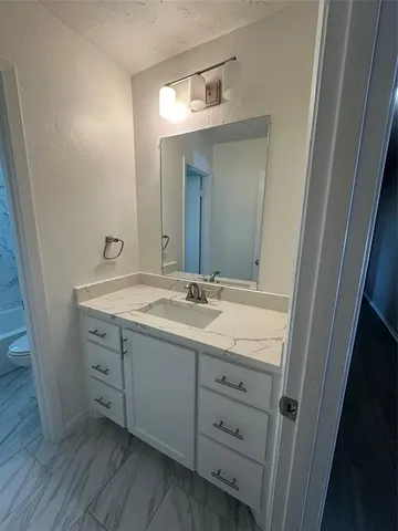 a bathroom with a double vanity sink and mirror with shower