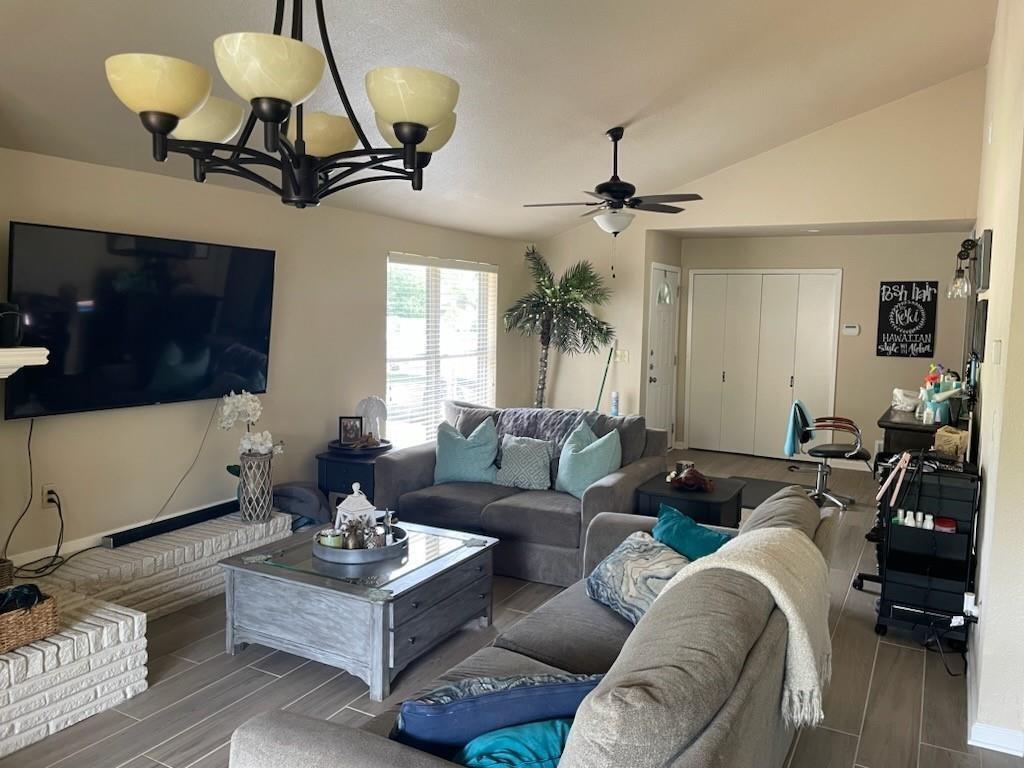 1315 North Floyd Road Richardson, TX 75080 - Photo 8 of 26 a living room with furniture a chandelier and a flat screen tv