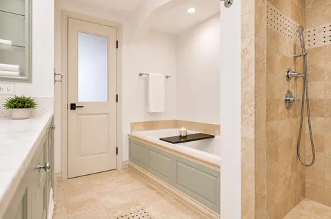 a bathroom with a granite countertop shower a mirror and a sink