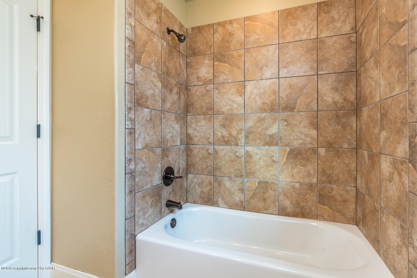 9203 Orry Avenue Amarillo, TX 79119 - Photo 17 of 22 a bathroom with a bathtub
