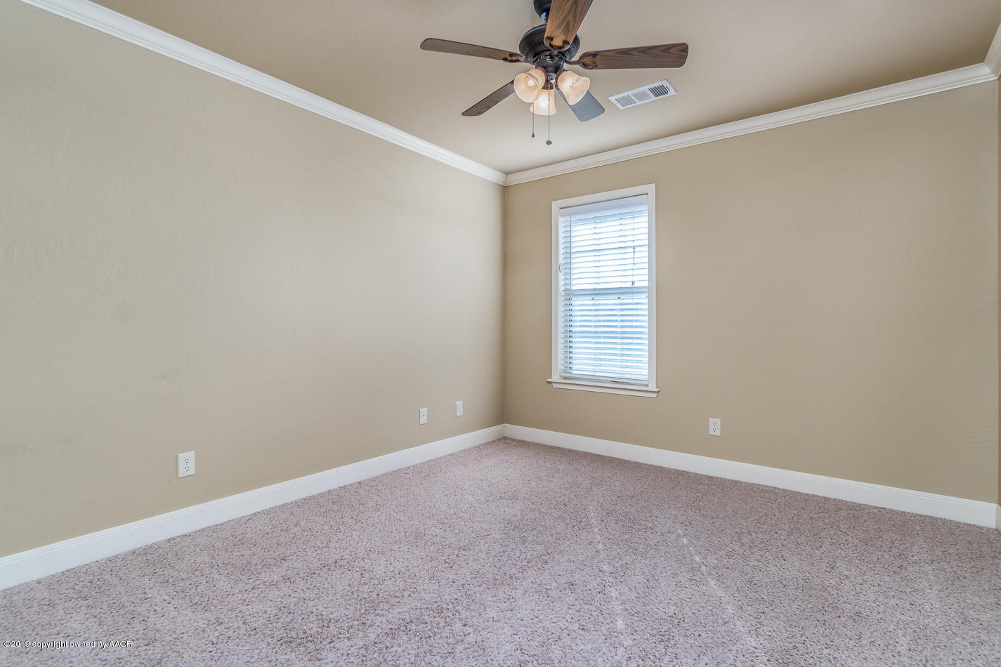 9203 Orry Avenue Amarillo, TX 79119 - Photo 18 of 22 an empty room with a window and a fan