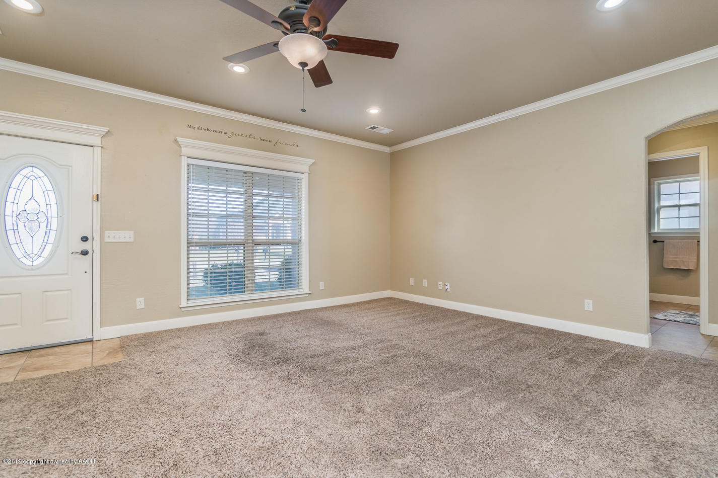 9203 Orry Avenue Amarillo, TX 79119 - Photo 5 of 22 an empty room with windows and fan
