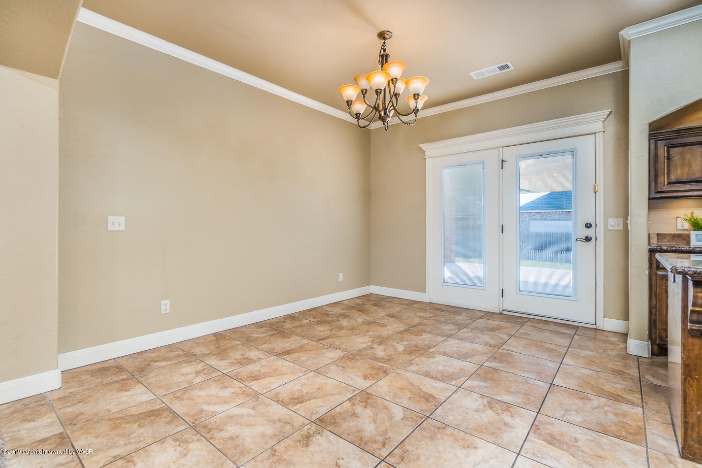 9203 Orry Avenue Amarillo, TX 79119 - Photo 6 of 22 a view of an empty room with a chandelier