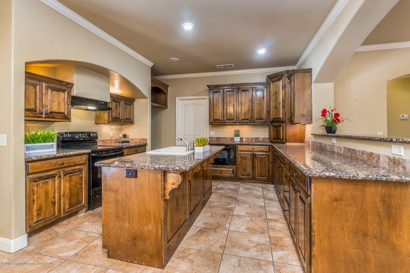 9203 Orry Avenue Amarillo, TX 79119 - Photo 7 of 22 a kitchen with stainless steel appliances granite countertop a stove a sink and a refrigerator