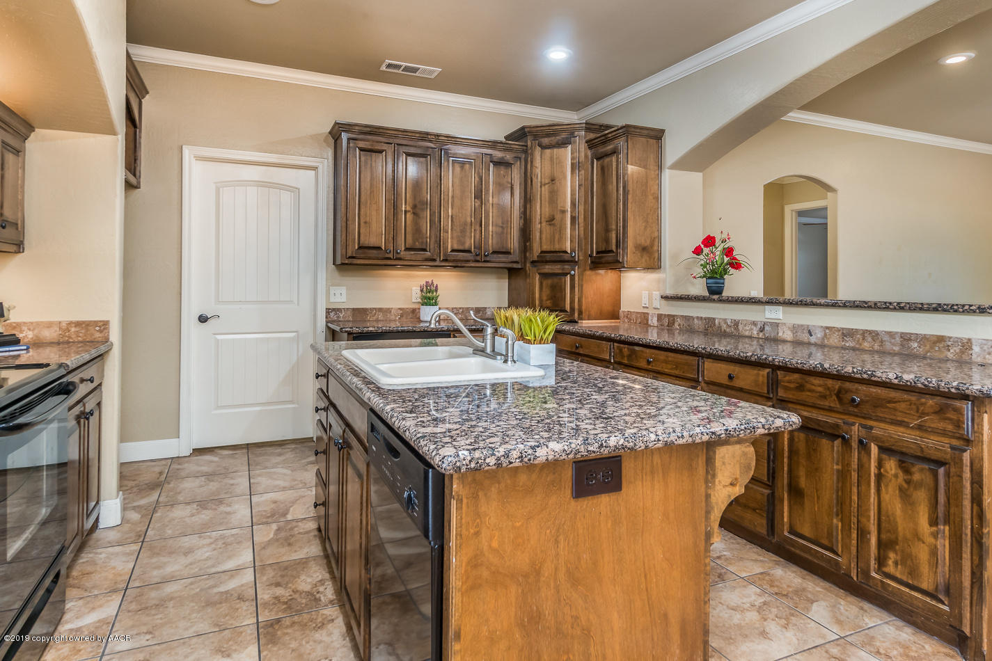 9203 Orry Avenue Amarillo, TX 79119 - Photo 9 of 22 a bathroom with a granite countertop sink and a mirror