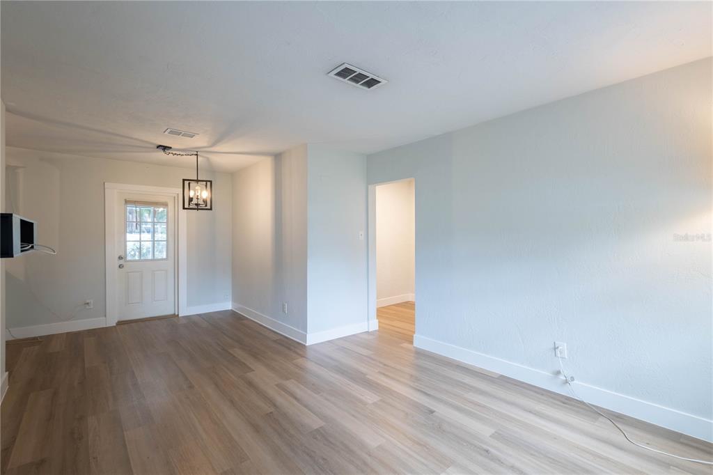 314 4th Avenue Southwest Ruskin, FL 33570 - Photo 5 of 30 an empty room with wooden floor and windows