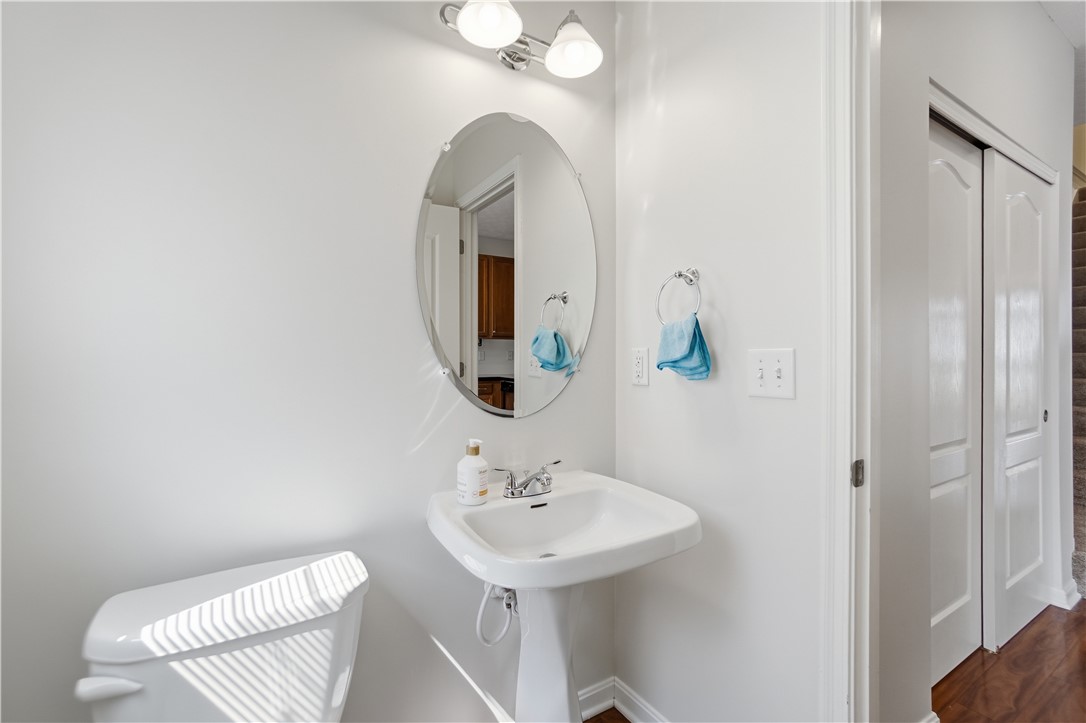 4294 Straight Arrow Road Dayton, OH 45430 - Photo 17 of 41 This bright bathroom features a pedestal sink and modern lighting, reflecting an elegant design.