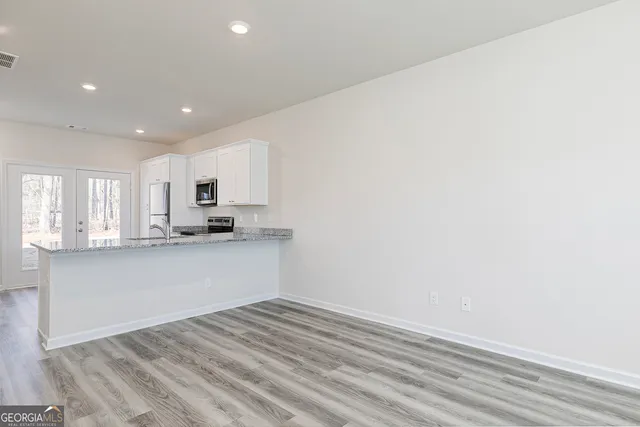 a view of kitchen with wooden floor