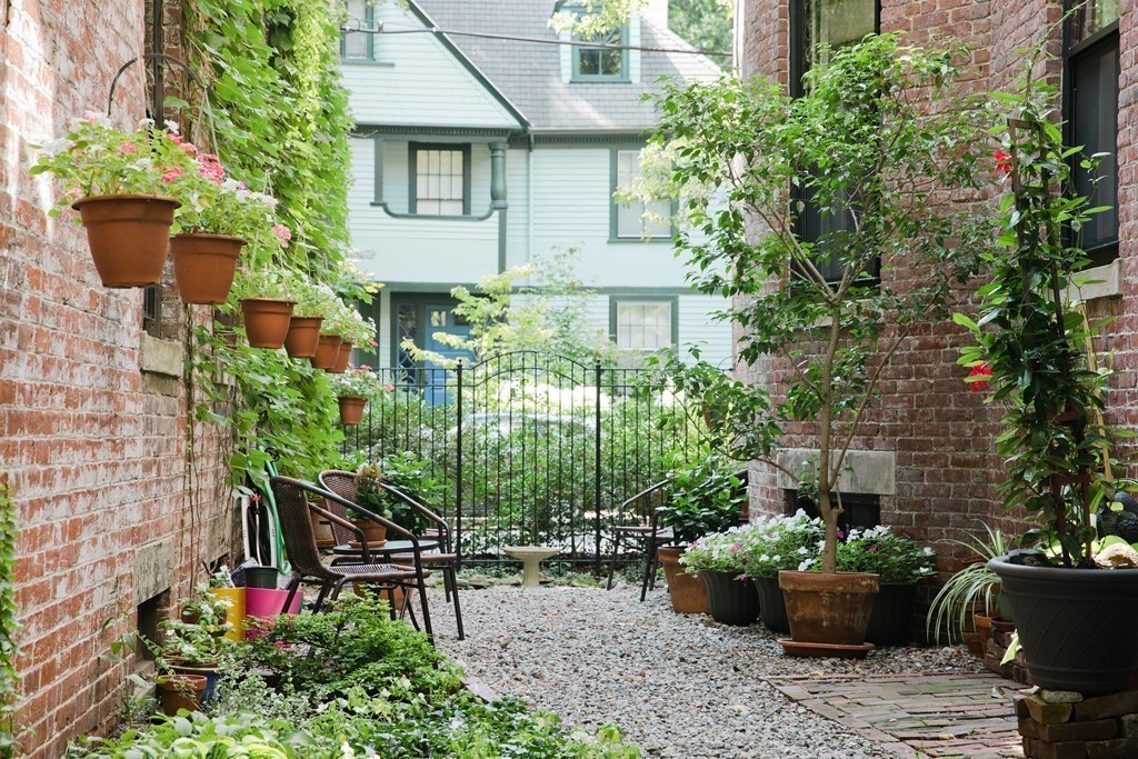 26 Hurlbut Street, Unit 2 Cambridge, MA 02138 - Photo 13 of 17 a view of a backyard with sitting area and garden