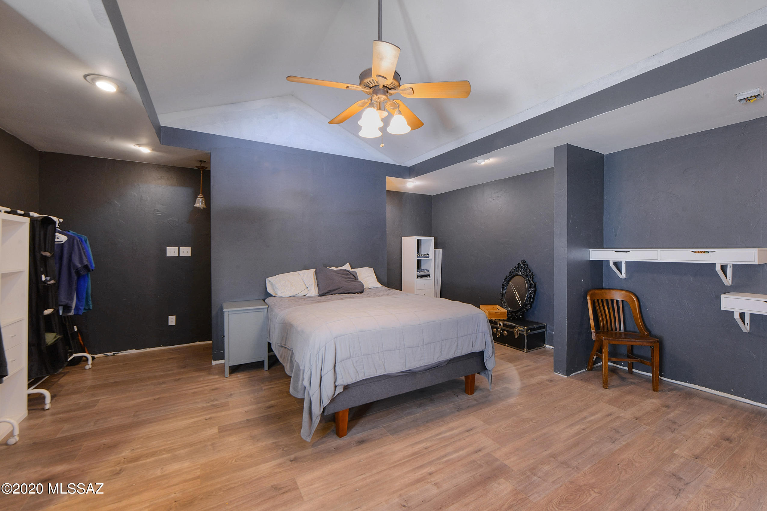 418 East Pastime Road Tucson, AZ 85705 - Photo 15 of 20 a bedroom with a bed and a chandelier