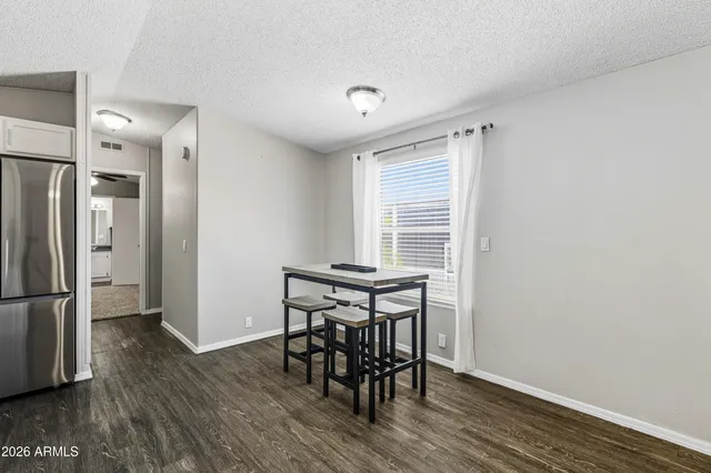 a view of a room with wooden floor furniture and windows