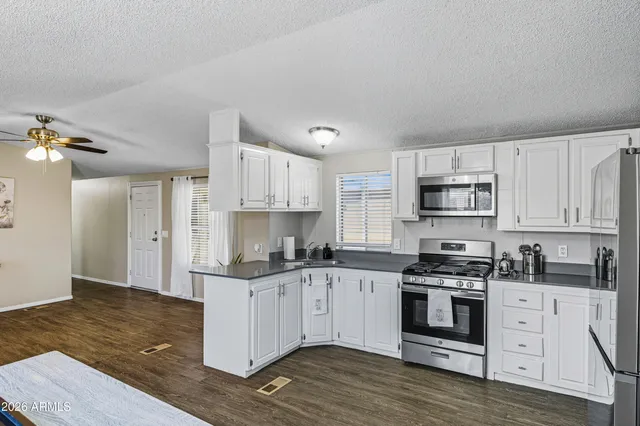 a kitchen with stainless steel appliances a stove top oven and cabinets
