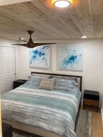 a bedroom with a bed and a painting on the wall