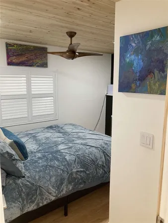 a bedroom with a bed and a wall painting