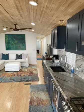 a kitchen with stainless steel appliances granite countertop a sink stove and cabinets