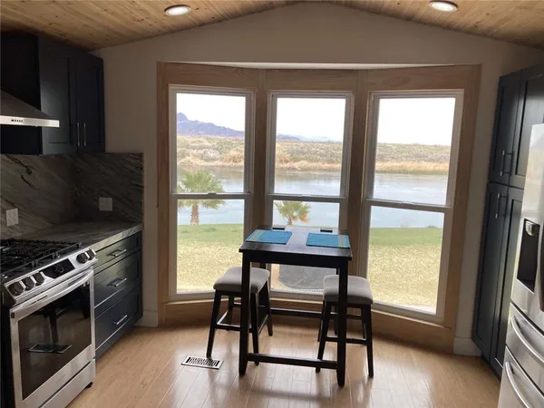 a kitchen with a table chairs and a stove