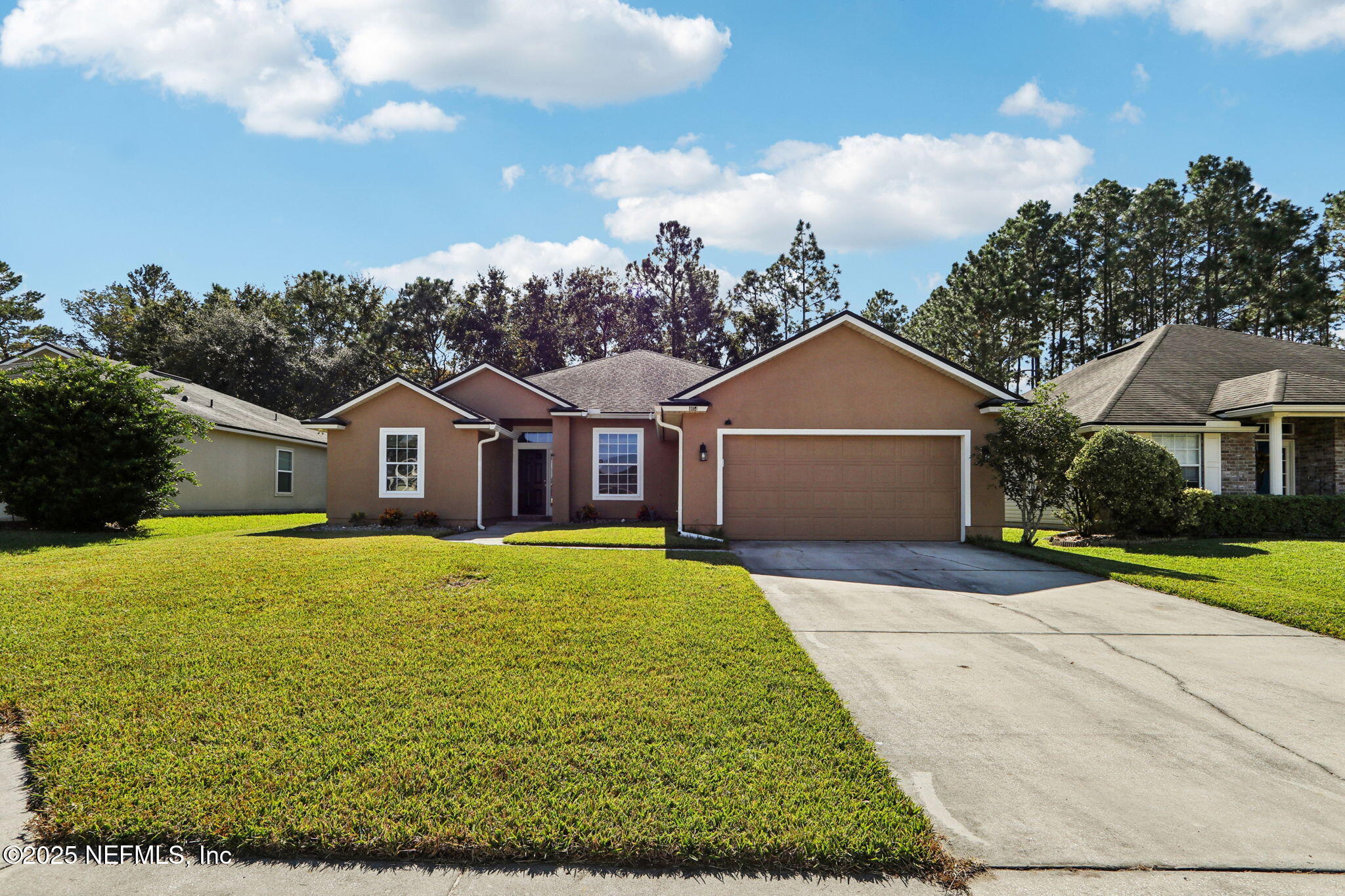 a front view of house with yard and green space