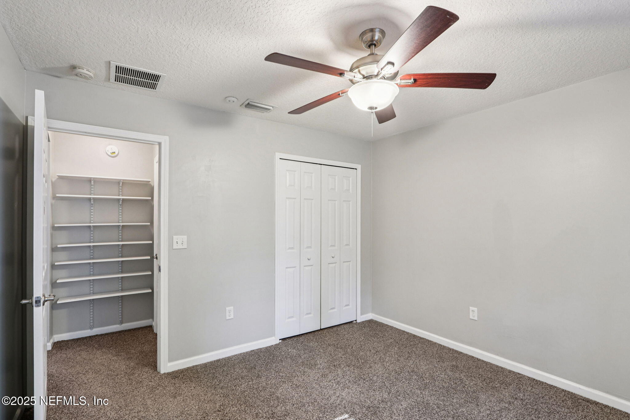 4054 Trail Ridge Road Middleburg, FL 32068 - Photo 22 of 48 a view of an empty room with a ceiling fan