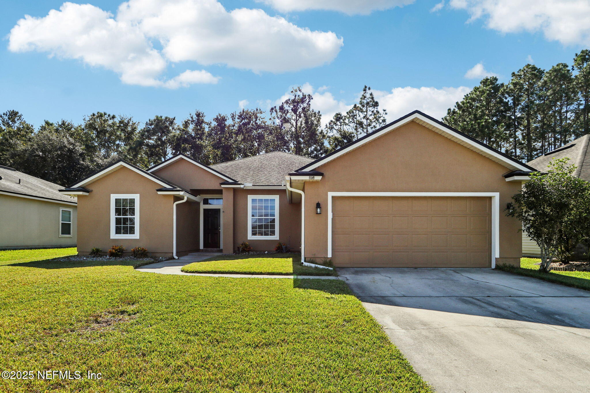 4054 Trail Ridge Road Middleburg, FL 32068 - Photo 43 of 48 a front view of a house with a yard and garage