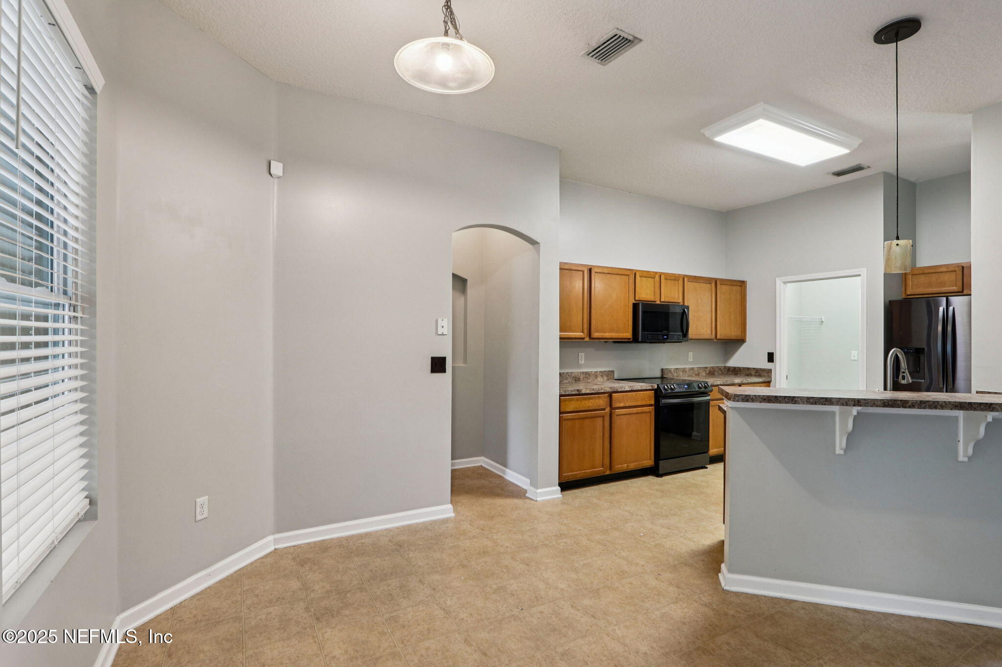 4054 Trail Ridge Road Middleburg, FL 32068 - Photo 46 of 48 a kitchen with stainless steel appliances granite countertop a refrigerator and a stove top oven