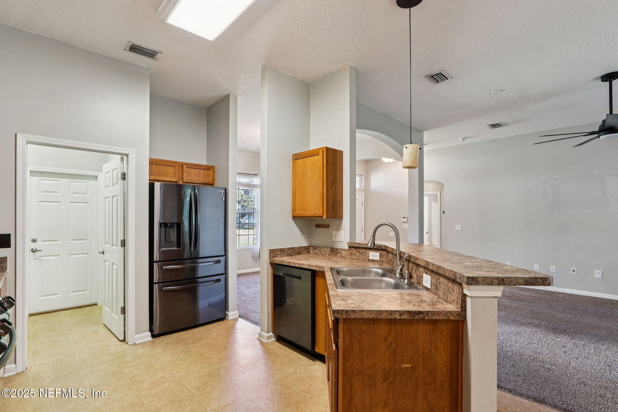 4054 Trail Ridge Road Middleburg, FL 32068 - Photo 10 of 48 a kitchen with stainless steel appliances granite countertop a refrigerator and a sink