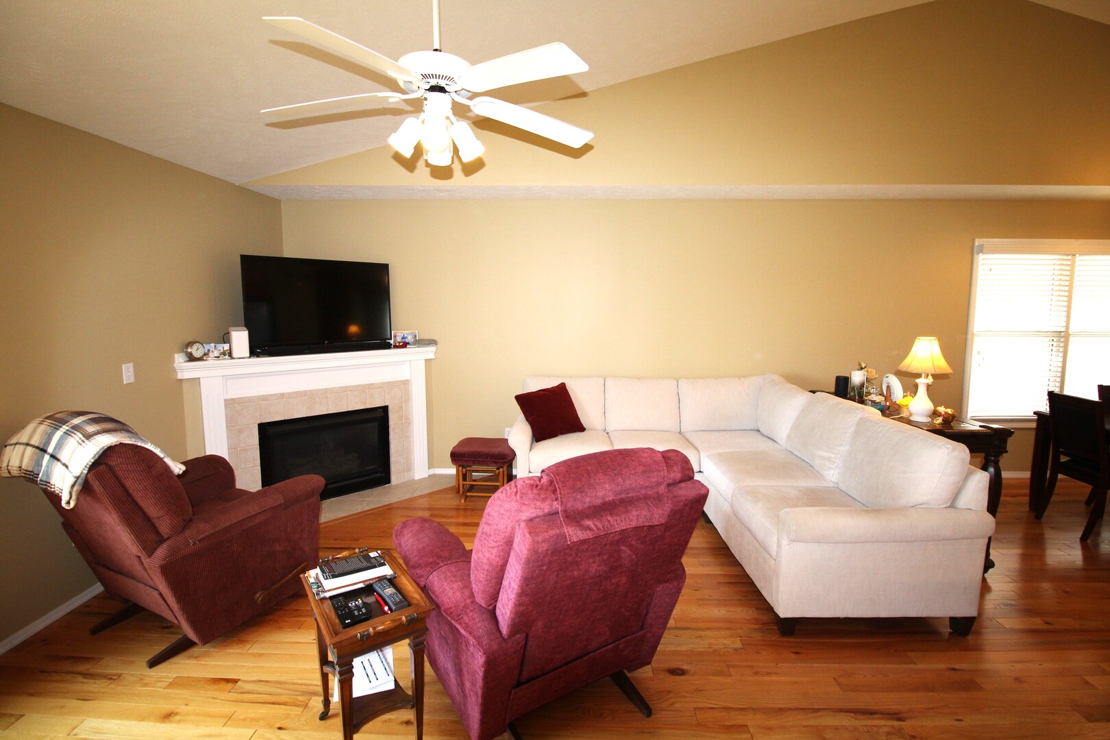 25 Oak Park Road Bloomington, IL 61701 - Photo 8 of 28 a living room with furniture a fireplace and a flat screen tv