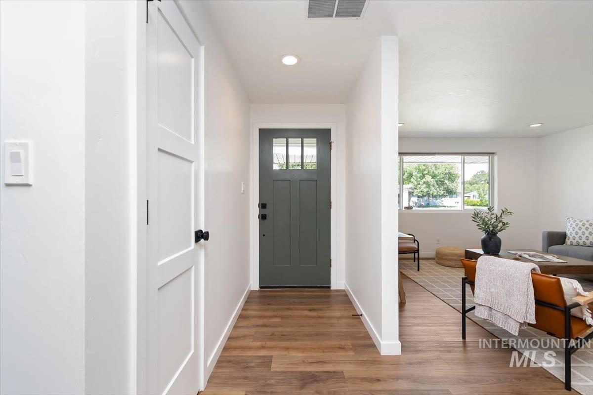 2217 North Middlefield Road Boise, ID 83704 - Photo 5 of 34 Entryway featuring wood-finish flooring and a contemporary dark green door with divided lites