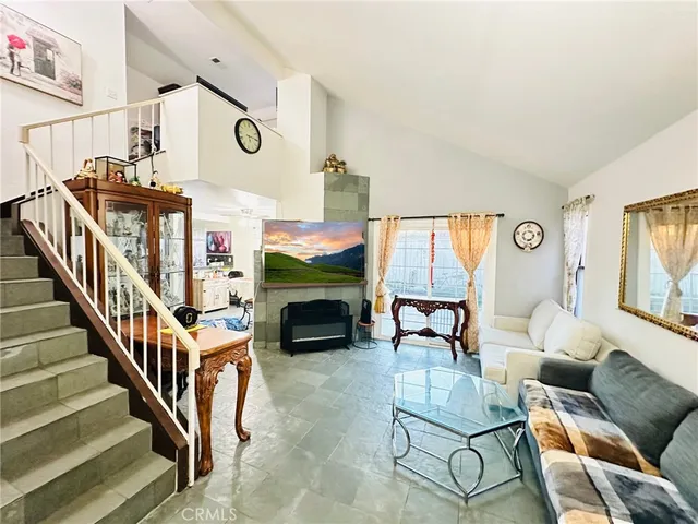 a view of an empty room with wooden floor and windows