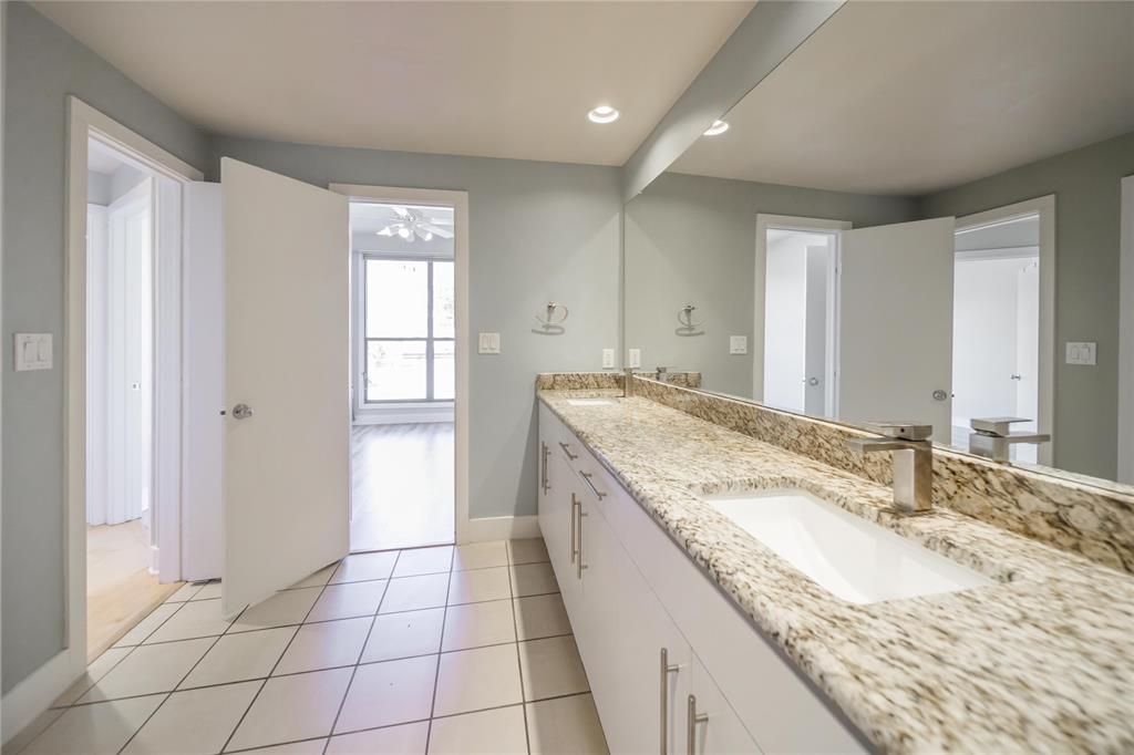 4414 Cedar Springs Road, Unit 214 Dallas, TX 75219 - Photo 22 of 29 Bathroom with light tile patterned flooring, double vanity, and recessed lighting
