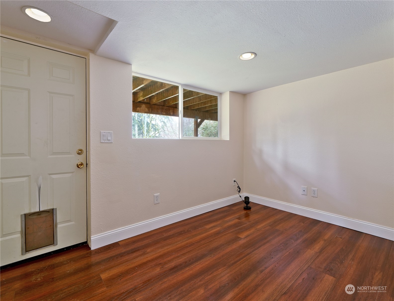 11261 145th Avenue Southeast Renton, WA 98059 - Photo 16 of 26 a view of a room with wooden floor and white walls
