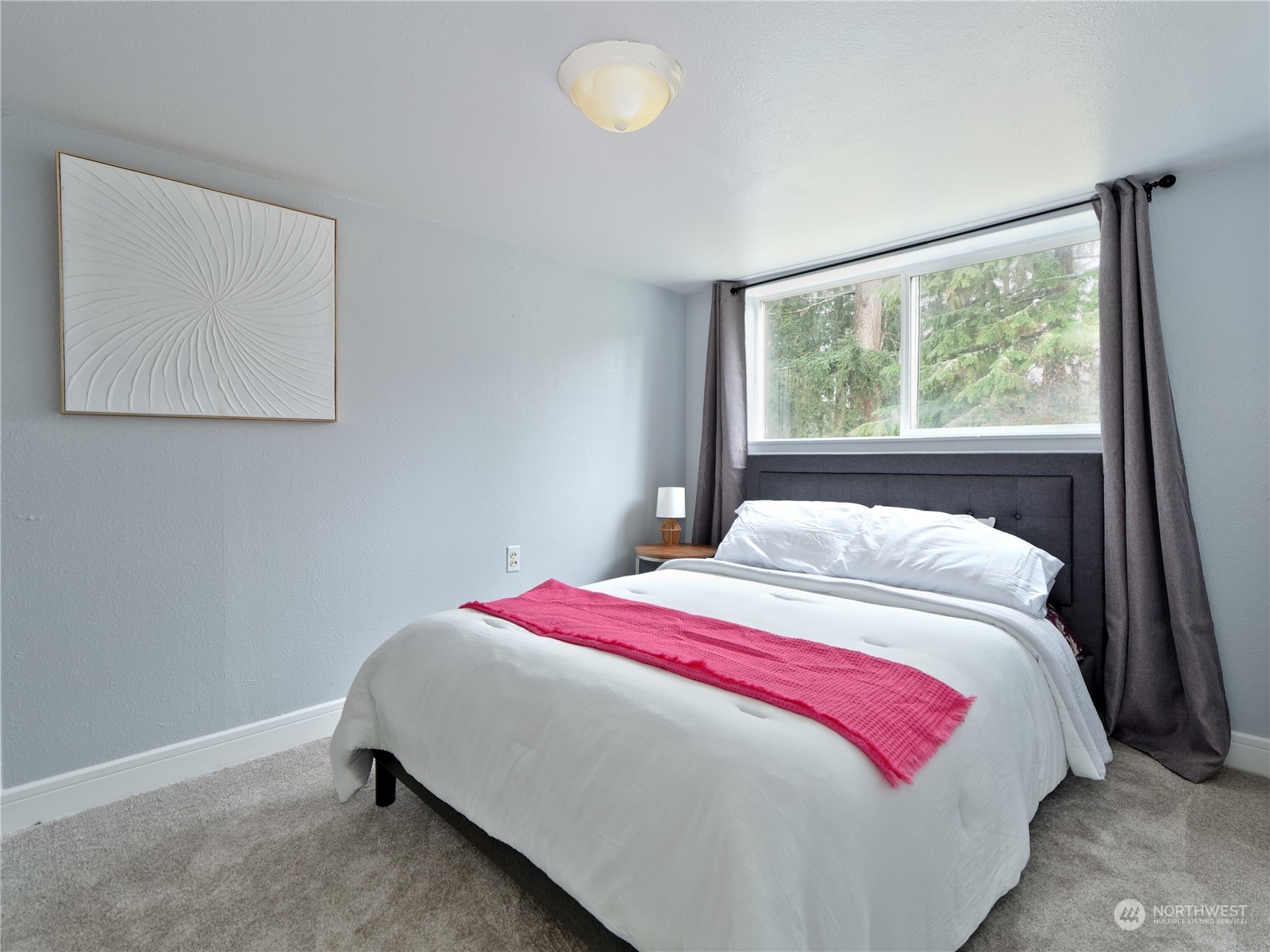 11261 145th Avenue Southeast Renton, WA 98059 - Photo 19 of 26 a bedroom with a bed and a window