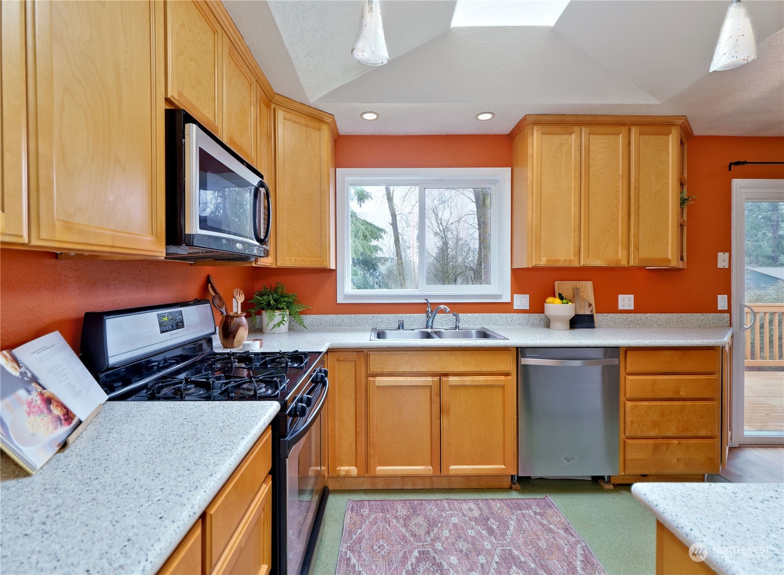 11261 145th Avenue Southeast Renton, WA 98059 - Photo 6 of 26 a kitchen with a stove a sink and a refrigerator