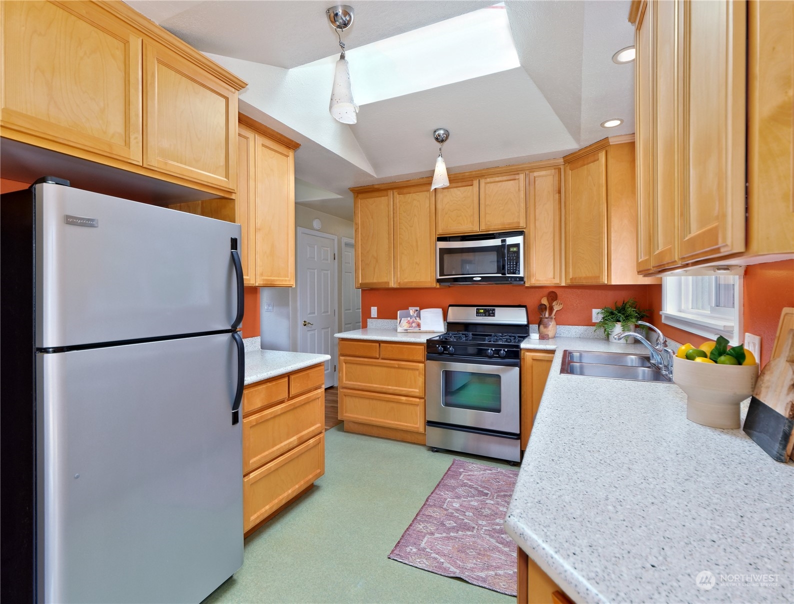 11261 145th Avenue Southeast Renton, WA 98059 - Photo 7 of 26 a kitchen with stainless steel appliances granite countertop a refrigerator stove microwave and sink