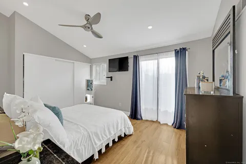 a bedroom with a bed and a chandelier