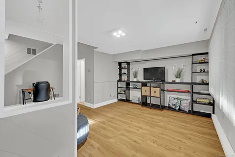 a living room with furniture and a wooden floor