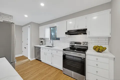 a kitchen with a stove a sink and a refrigerator