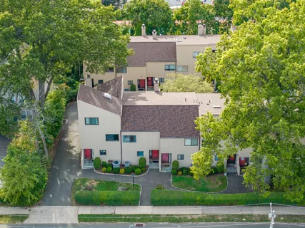 an aerial view of residential houses with outdoor space