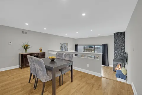 a view of a dining room with furniture and wooden floor